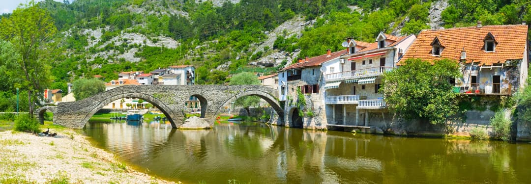 The multi-arched stone bridge and riverfront houses at Rijeka Crnojevića