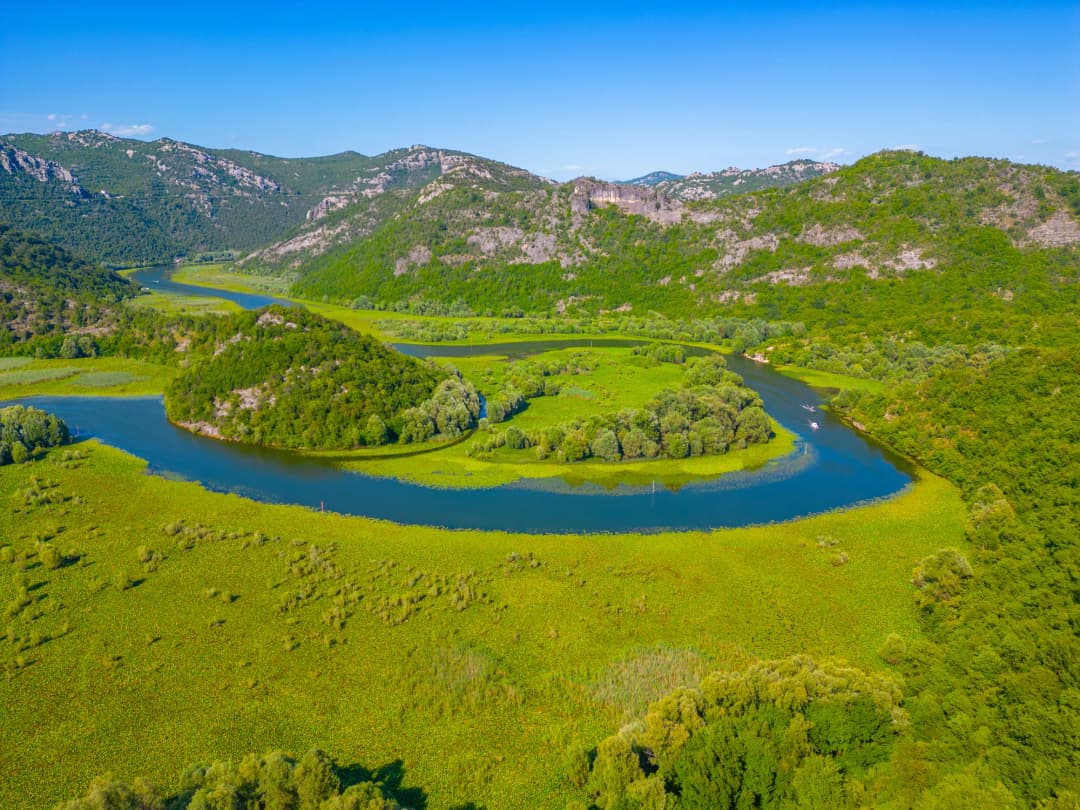 Aerial view of the Rijeka Crnojevića waterway winding through Lake Skadar wetlands