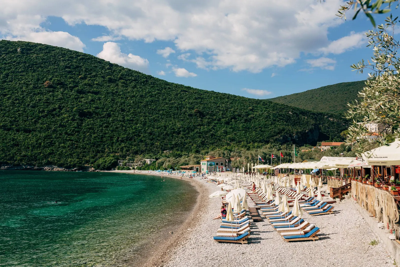 Long pebble beach and restaurant frontage at Žanjice on Luštica