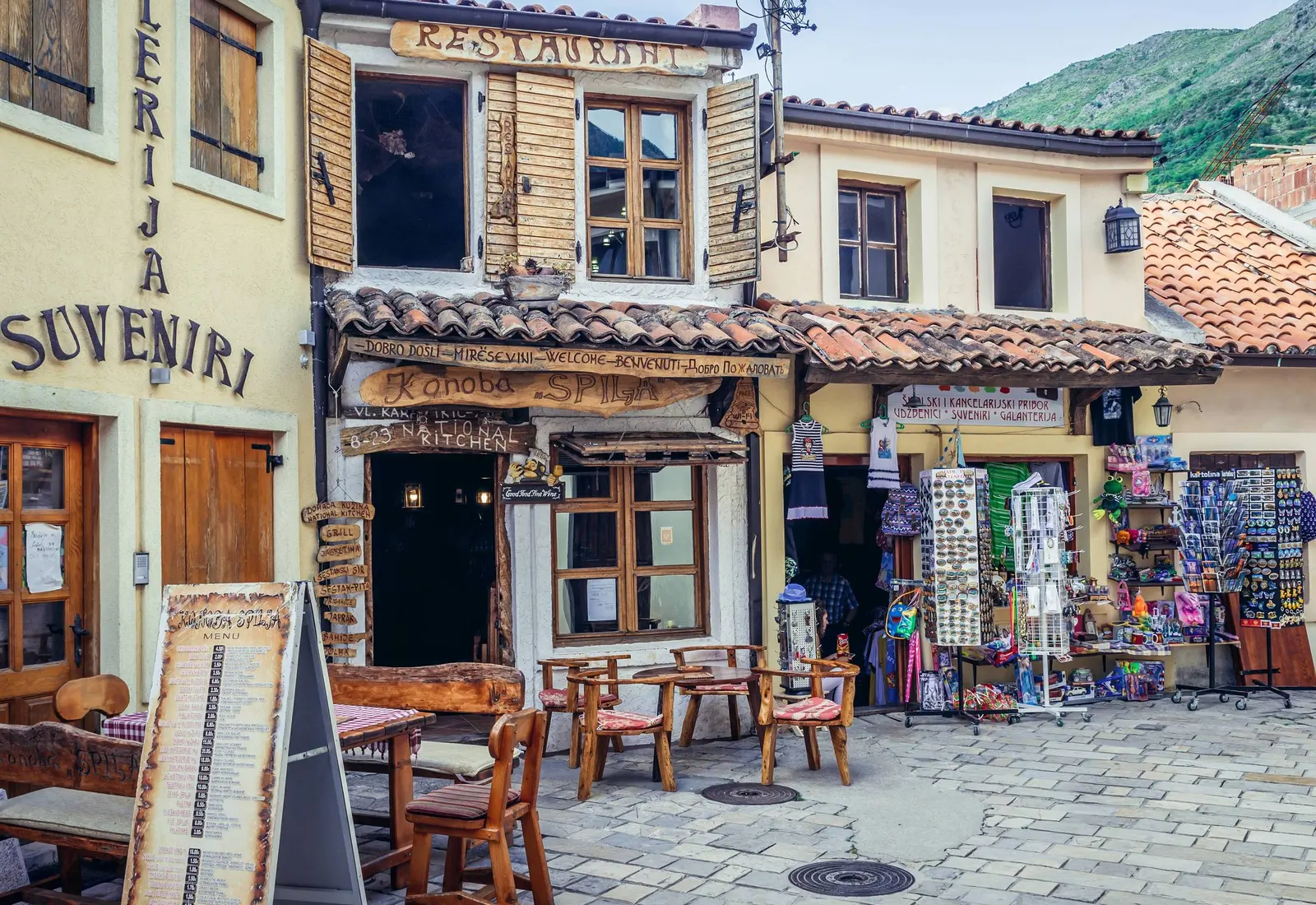 Cafes and craft displays along the stone bazaar street below Stari Bar
