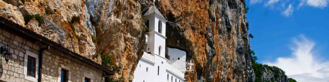 Gornji manastir Ostrog uzidan u narandžastu liticu iznad doline