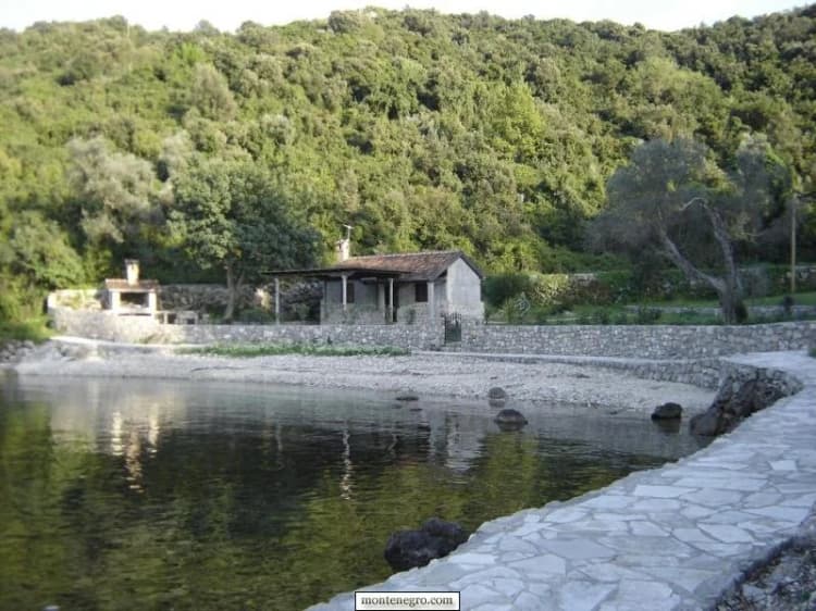 Small sheltered cove with a stone path near Rose