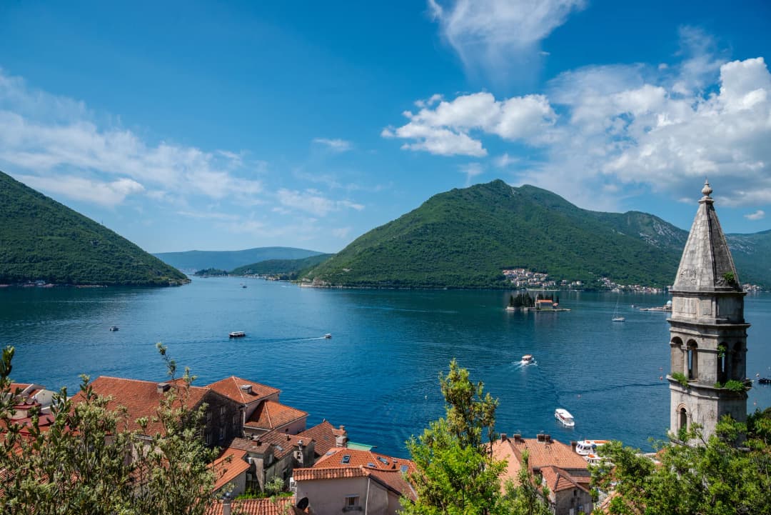 The steep stone steps of the fortress climb with a panoramic view of Kotor Bay unfolding below