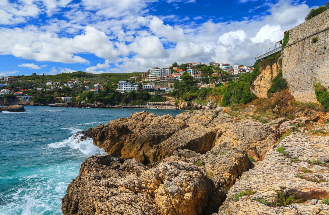 The ramparts of Ulcinj's Kalaja fortress rising directly above the rocky shore