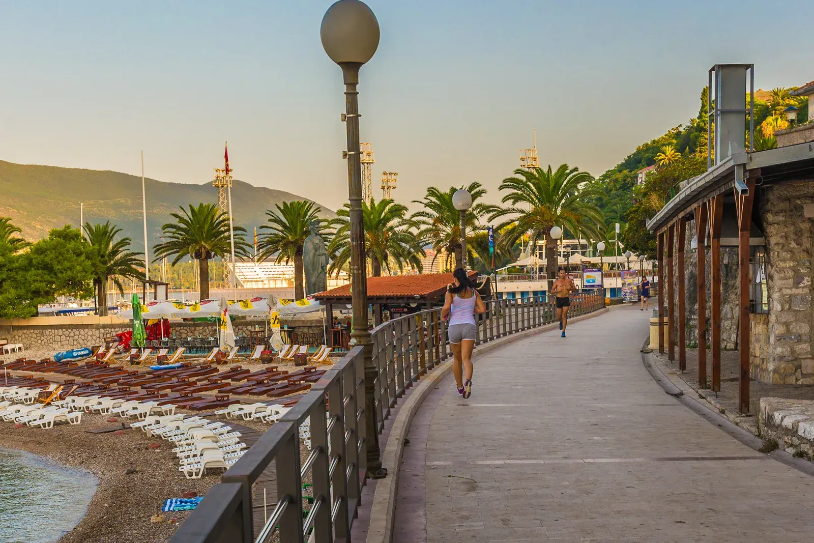 The palm-lined Pet Danica seaside promenade in Herceg Novi at golden hour