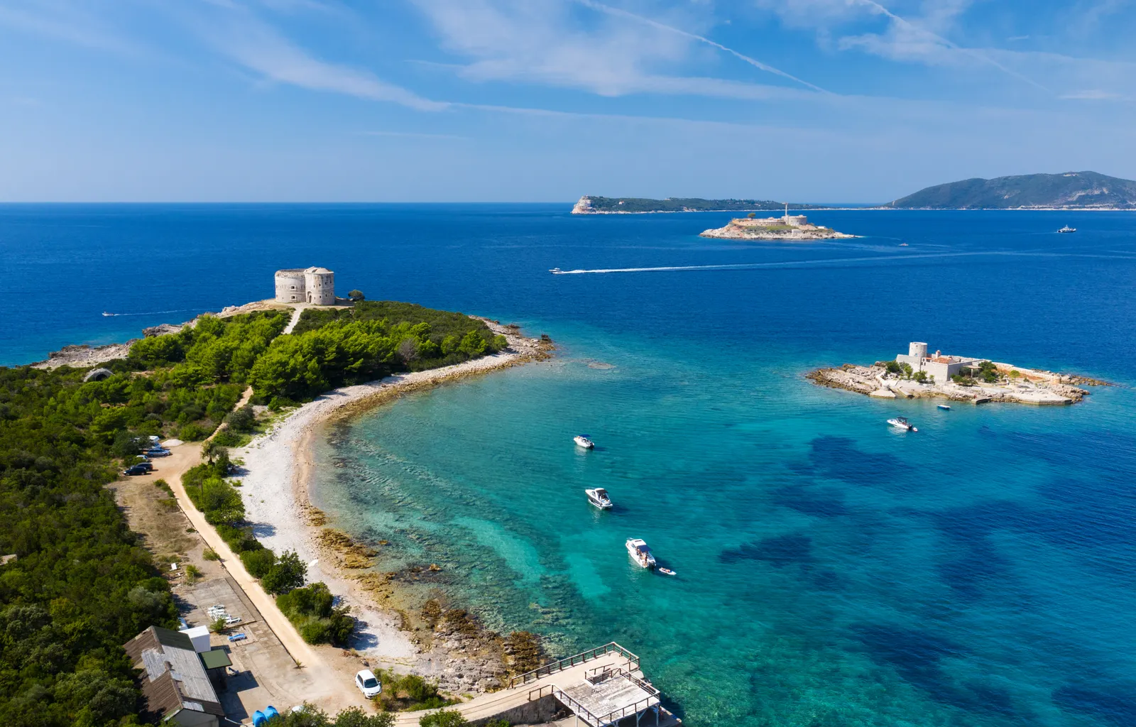 Mamula island fortress sitting low in the strait between the Luštica and Prevlaka headlands, with open sea beyond.